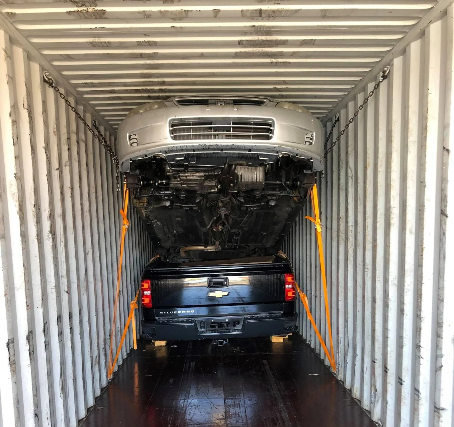 Company operation securing two vehicles inside a container